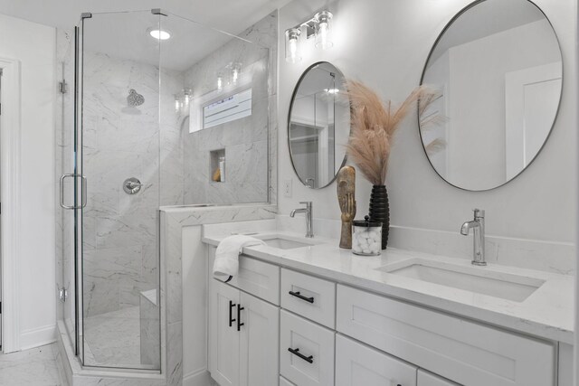 full bathroom with marble finish floors, a marble finish shower, and double vanity