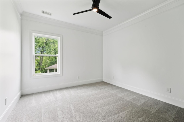 carpeted empty room featuring ornamental molding, a ceiling fan, and baseboards