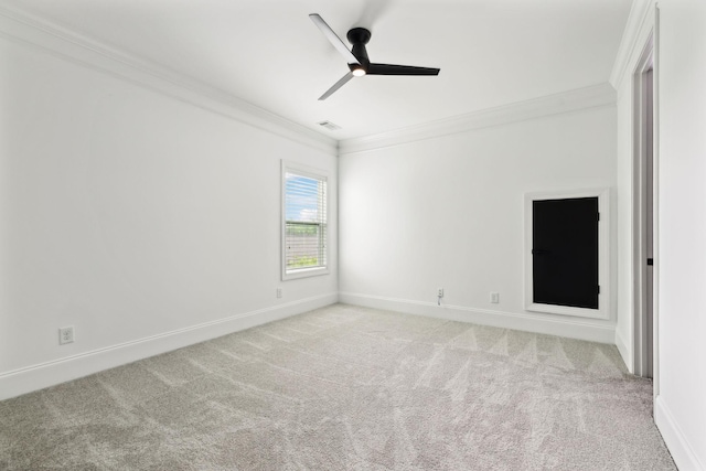 carpeted empty room with ornamental molding, ceiling fan, and baseboards