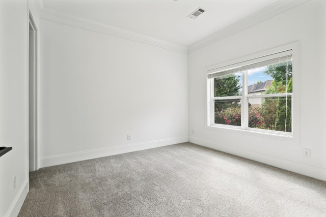 unfurnished room with ornamental molding, carpet floors, and baseboards