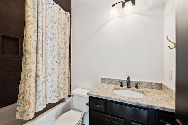 bathroom featuring toilet, vanity, and shower / tub combo