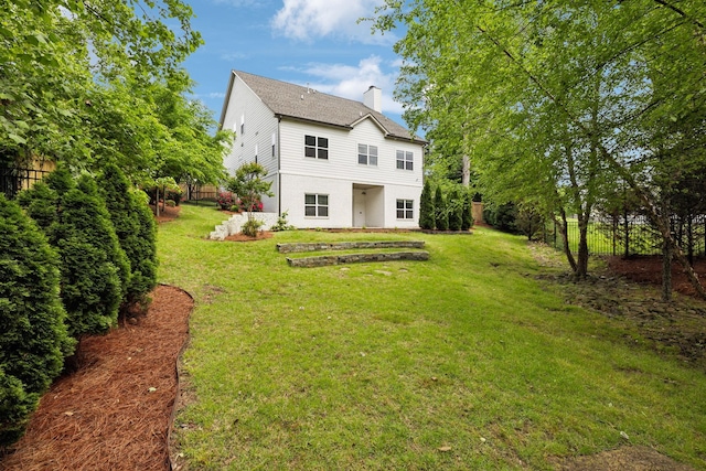 back of house with a chimney and stucco siding