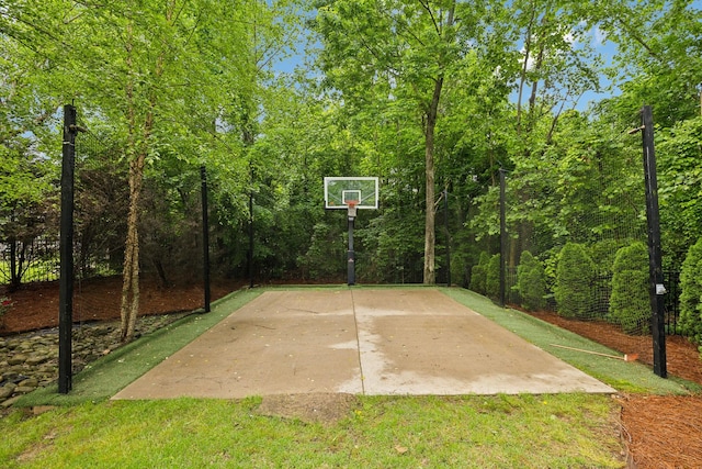 view of sport court featuring community basketball court and a yard
