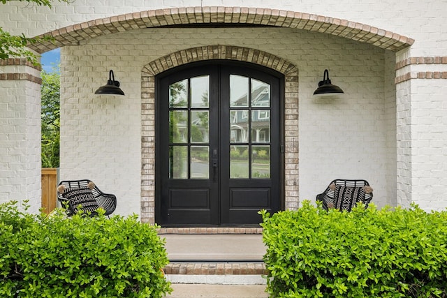property entrance with french doors and brick siding