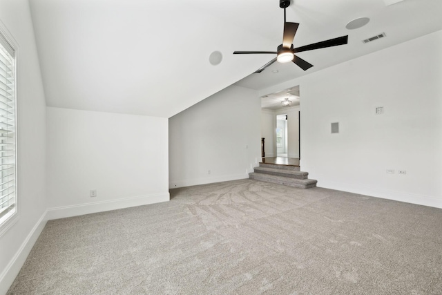 unfurnished living room featuring a ceiling fan, carpet flooring, stairs, and baseboards