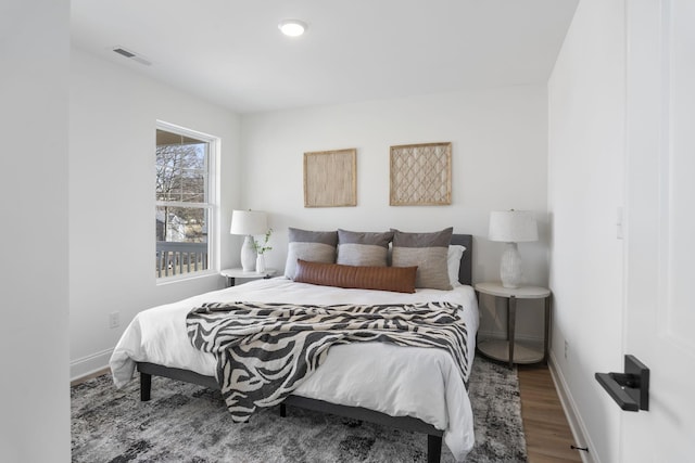 bedroom featuring wood finished floors and baseboards