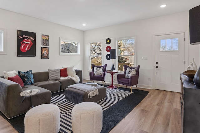 living room with light wood-type flooring, recessed lighting, and baseboards