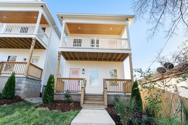 view of front facade with a balcony and covered porch