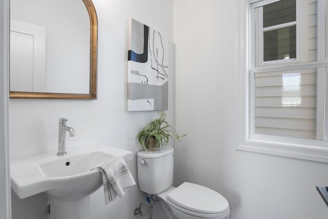 bathroom with toilet and a sink