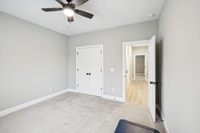 2219 Ovoca Rd, Tullahoma, TN 37388 - unfurnished bedroom featuring light colored carpet, baseboards, and ceiling fan