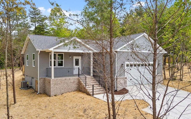 222 Grayson Way, Signal Mountain, TN 37377 - view of front of house with a porch, a shingled roof, an attached garage, central AC unit, and driveway