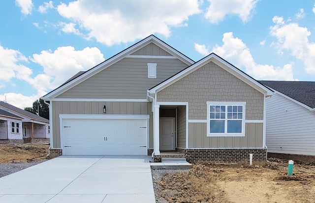 128 Holly Rdg, Antioch, TN 37013 - view of front of house with board and batten siding, driveway, and an attached garage