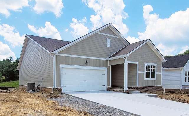 128 Holly Rdg, Antioch, TN 37013 - view of front of property with an attached garage, concrete driveway, board and batten siding, and a shingled roof