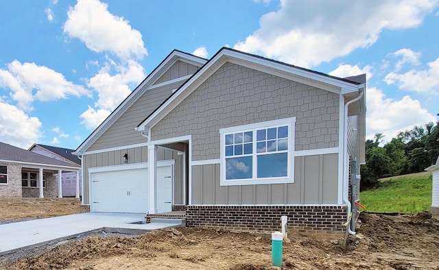 128 Holly Rdg, Antioch, TN 37013 - view of front facade with board and batten siding, concrete driveway, and an attached garage