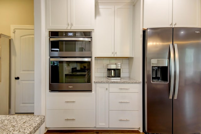 864 S Ridge Trl, Clarksville, TN 37043 - kitchen featuring stainless steel appliances, white cabinetry, light stone counters, and decorative backsplash