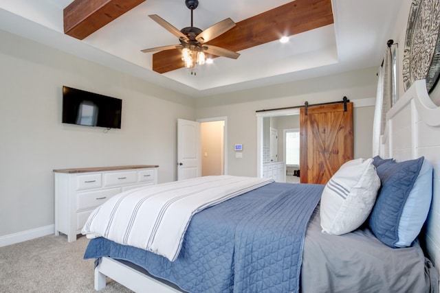 864 S Ridge Trl, Clarksville, TN 37043 - bedroom featuring light colored carpet, a barn door, a raised ceiling, connected bathroom, and baseboards
