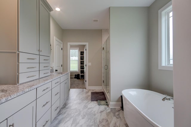864 S Ridge Trl, Clarksville, TN 37043 - bathroom featuring a shower stall, double vanity, a soaking tub, and baseboards