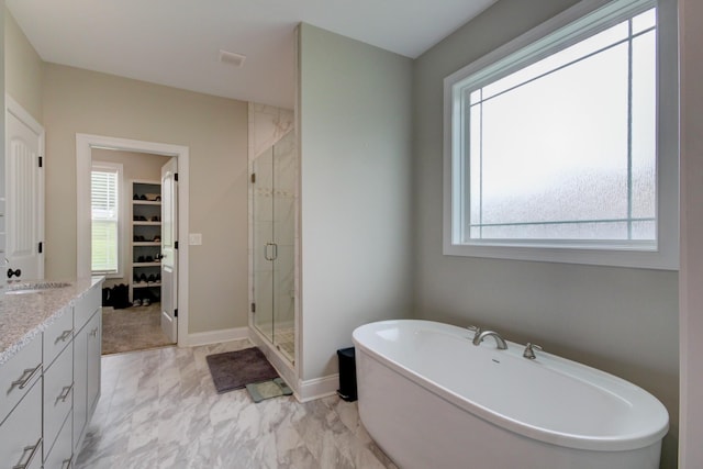 864 S Ridge Trl, Clarksville, TN 37043 - bathroom with a shower stall, a spacious closet, vanity, a freestanding tub, and baseboards