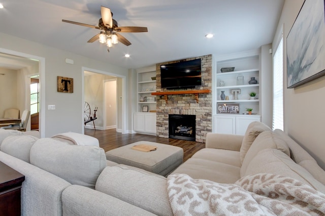 864 S Ridge Trl, Clarksville, TN 37043 - living room featuring a ceiling fan, dark wood-style flooring, baseboards, a fireplace, and built in features