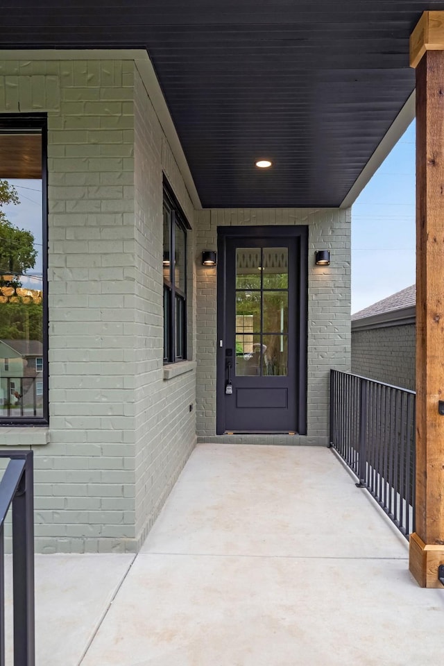 property entrance featuring brick siding
