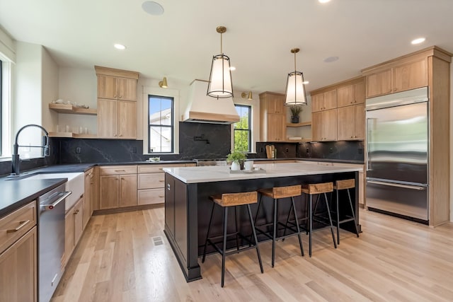 kitchen featuring open shelves, stainless steel appliances, light brown cabinets, and recessed lighting