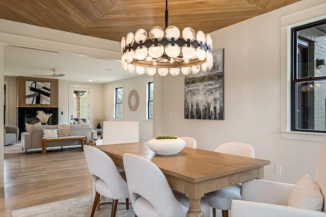dining space with wooden ceiling, wood finished floors, and a chandelier