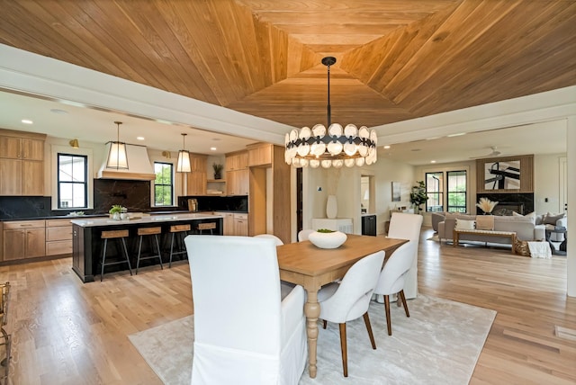 dining area with wood ceiling, a chandelier, light wood finished floors, a raised ceiling, and recessed lighting