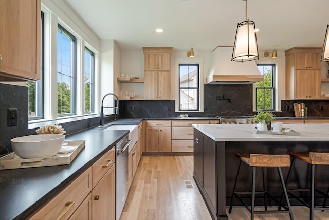 kitchen with open shelves, custom range hood, healthy amount of natural light, light brown cabinetry, and recessed lighting
