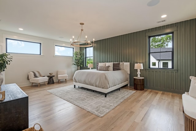 bedroom with multiple windows, light wood finished floors, a chandelier, and recessed lighting
