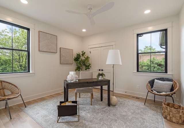office with healthy amount of natural light, light wood-type flooring, a ceiling fan, recessed lighting, and baseboards