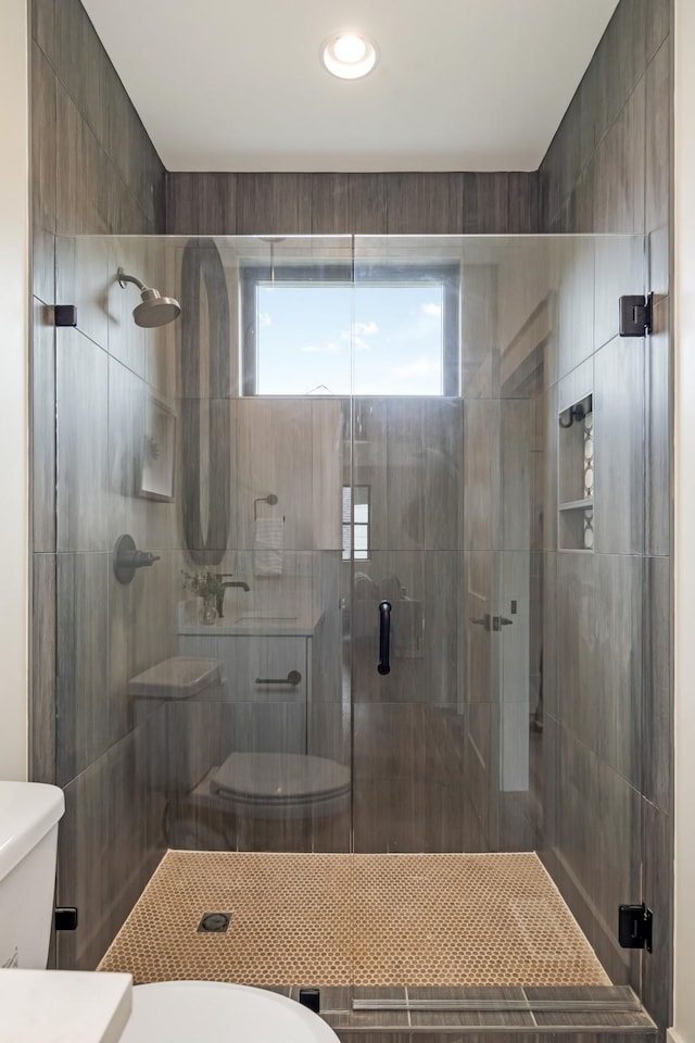bathroom with toilet and a stall shower
