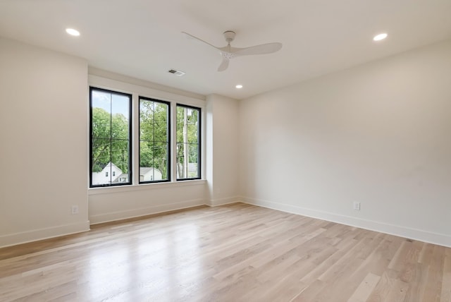 empty room with ceiling fan, baseboards, light wood finished floors, and recessed lighting