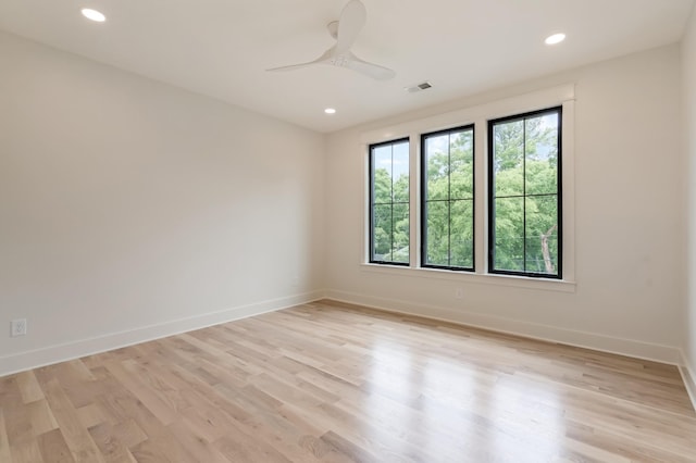 empty room with baseboards, light wood-style floors, recessed lighting, and ceiling fan