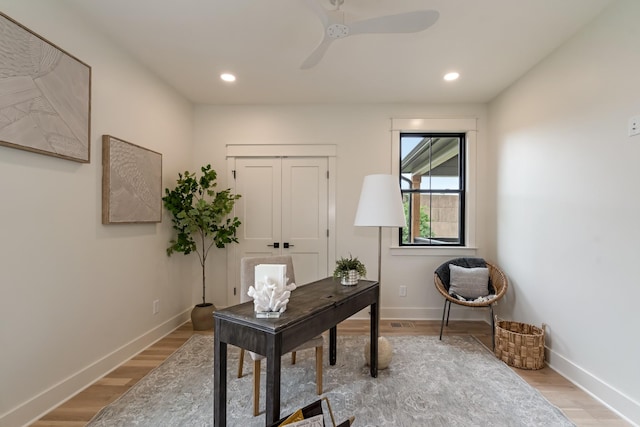 office space featuring light wood-style flooring, baseboards, a ceiling fan, and recessed lighting