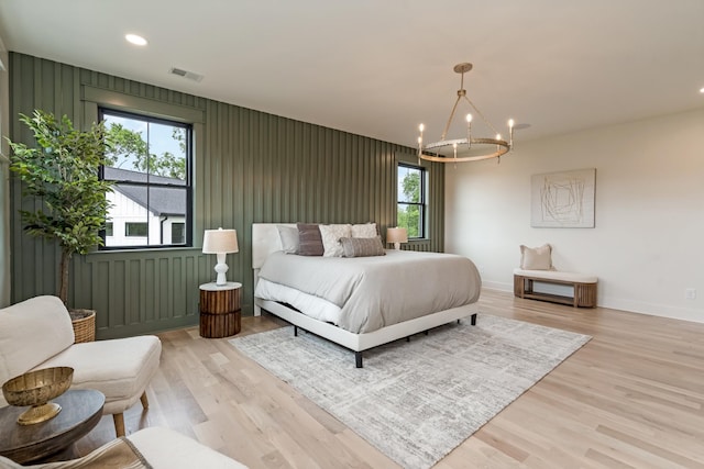 bedroom featuring a chandelier, baseboards, light wood-style flooring, and recessed lighting
