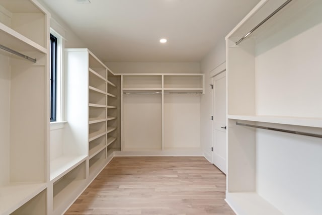 walk in closet with light wood-style flooring