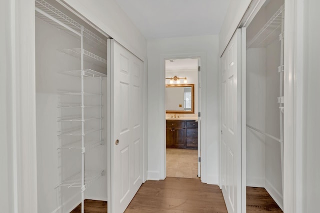 hall featuring dark wood-style floors and a sink