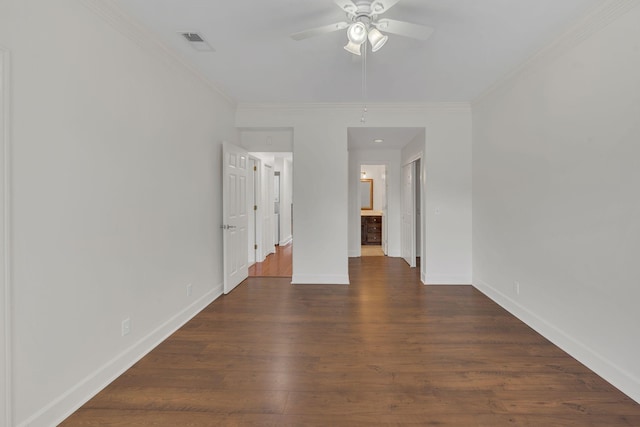 unfurnished bedroom featuring ornamental molding, baseboards, wood finished floors, ensuite bath, and ceiling fan
