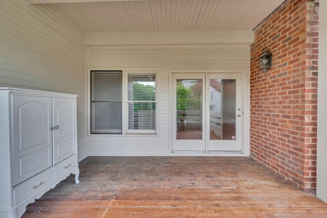 property entrance featuring a wooden deck and french doors