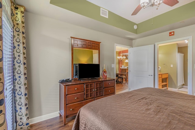 1410 Hurley Dr Unit 103, Sevierville, TN 37862 - bedroom featuring wood finished floors, baseboards, a ceiling fan, and connected bathroom