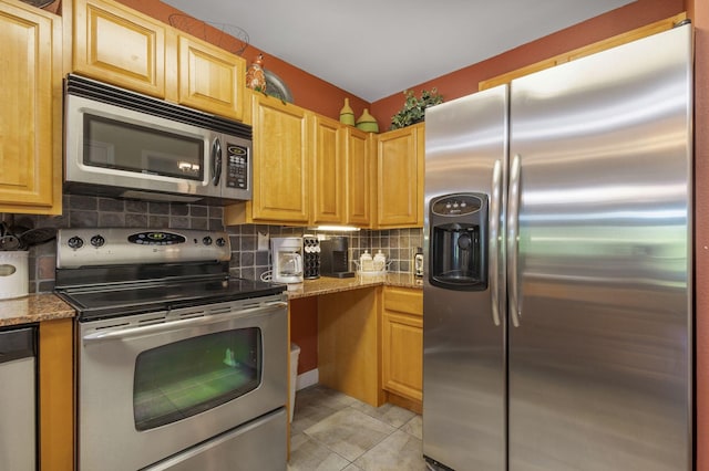 1410 Hurley Dr Unit 103, Sevierville, TN 37862 - kitchen featuring stainless steel appliances, tasteful backsplash, stone counters, and light tile patterned flooring