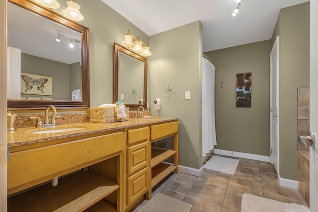 1410 Hurley Dr Unit 103, Sevierville, TN 37862 - bathroom with rail lighting, baseboards, double vanity, and a shower with curtain