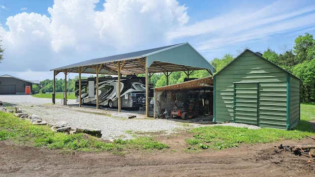 530 Glasgow Branch Rd, Hartsville, TN 37074 - view of parking featuring a carport and an outbuilding