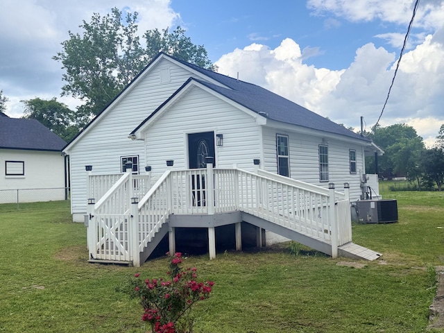 rear view of house with central AC, a wooden deck, and stairs