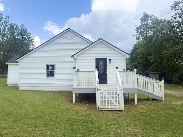 back of house featuring a deck and a yard