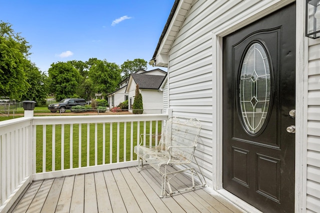 entrance to property with a lawn