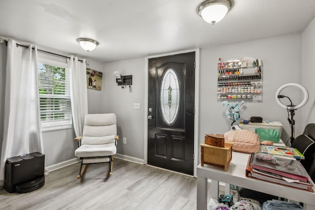 foyer with wood finished floors and baseboards