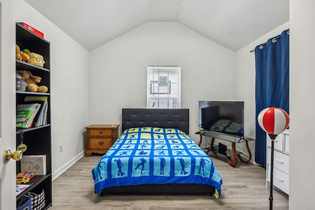 bedroom featuring wood finished floors and vaulted ceiling