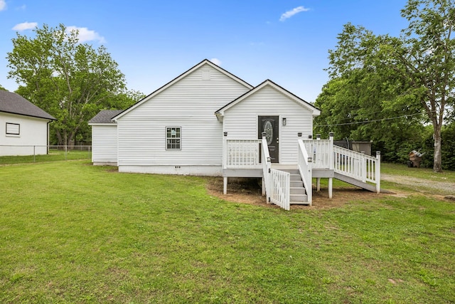 rear view of property featuring a wooden deck and crawl space
