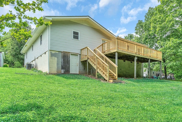rear view of house with a wooden deck, central AC unit, a lawn, and stairs